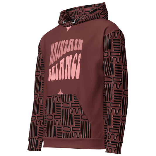 Side view of a maroon graphic print pullover hoodie with a pink wavy "Maintain Balance" graphic and a black geometric tribal pattern on the sleeves and kangaroo pocket|IslandWear Fashion