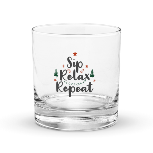 Clear, heavy-bottomed rocks glass or whiskey tumbler with a festive "Sip Relax Repeat" graphic, Christmas trees, and star | IslandWear Fashion