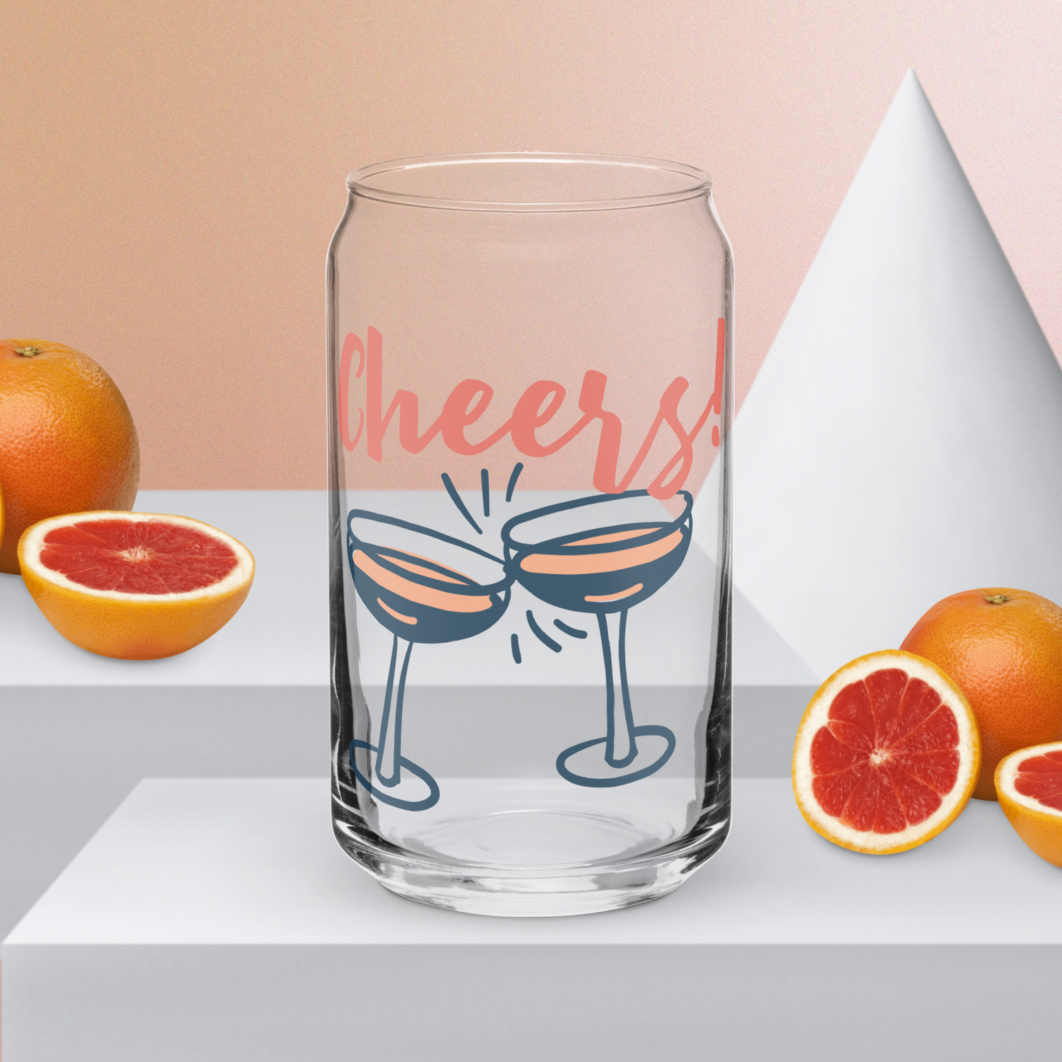 ​Clear can-shaped glass tumbler with pink "Cheers!" script and two clinking cocktail glasses design.