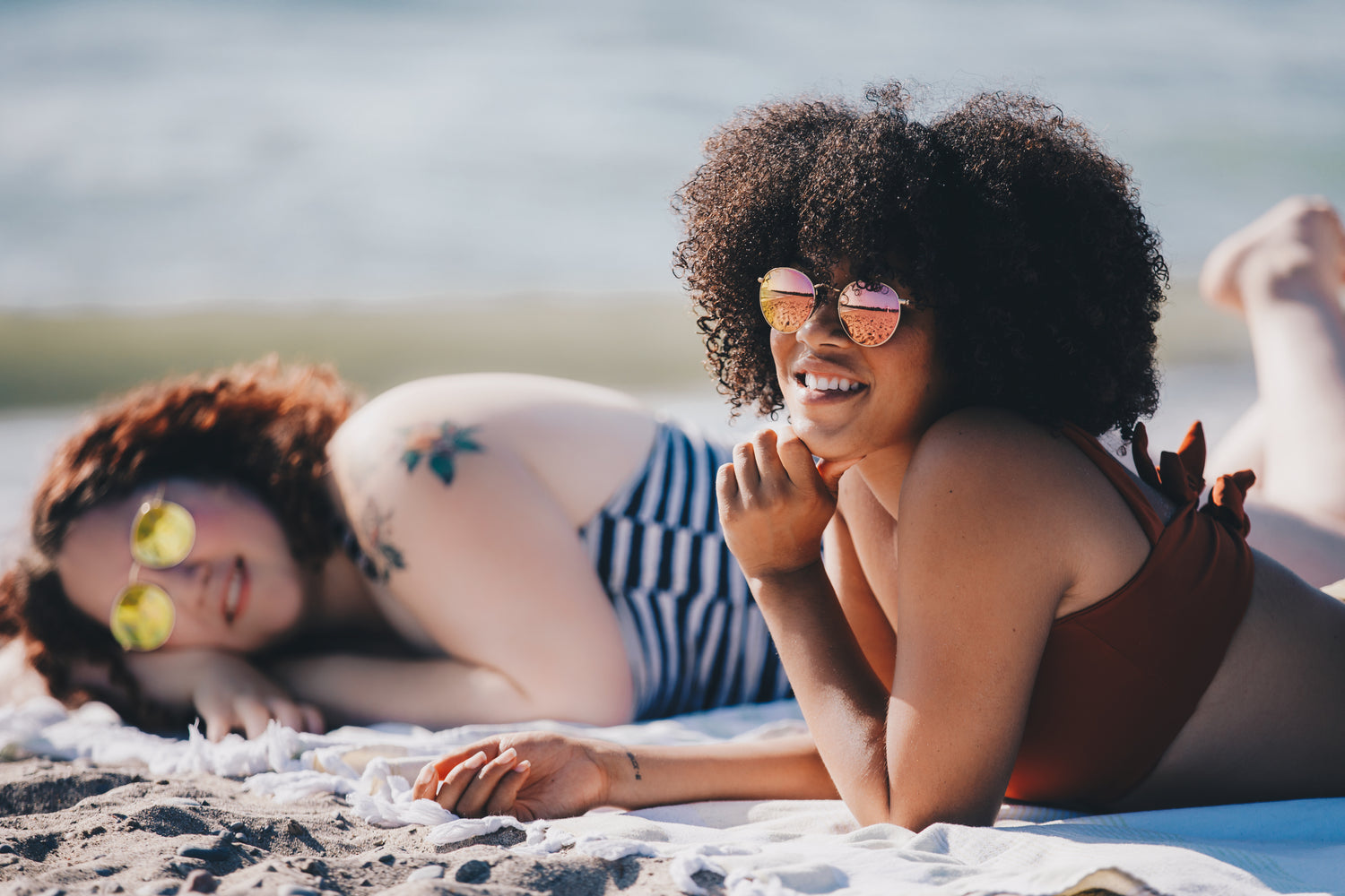 women wearing sunglasses on the beach