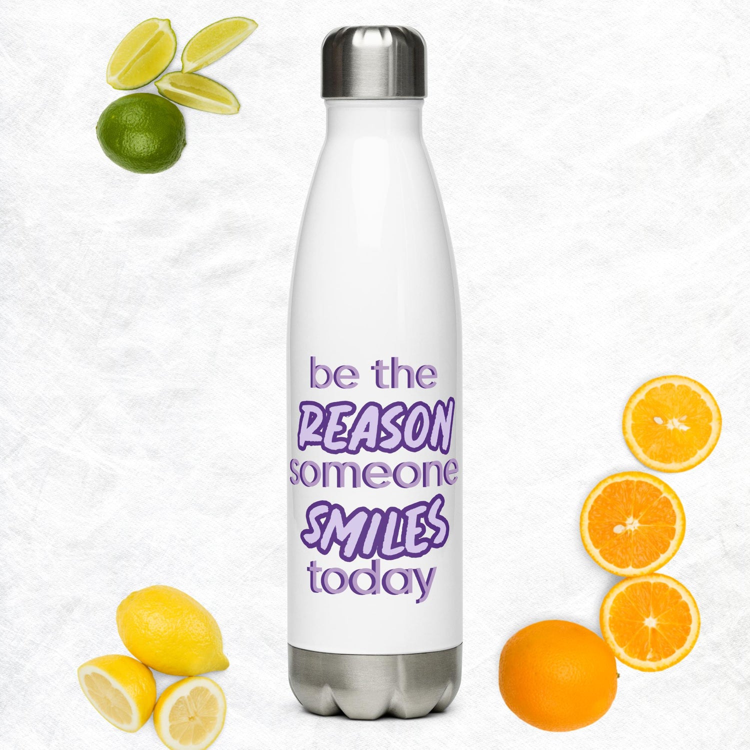 ​White stainless steel motivational water bottle with purple "Be the reason someone smiles today" quote, surrounded by lemons, limes, and oranges| IslandWear Fashion 