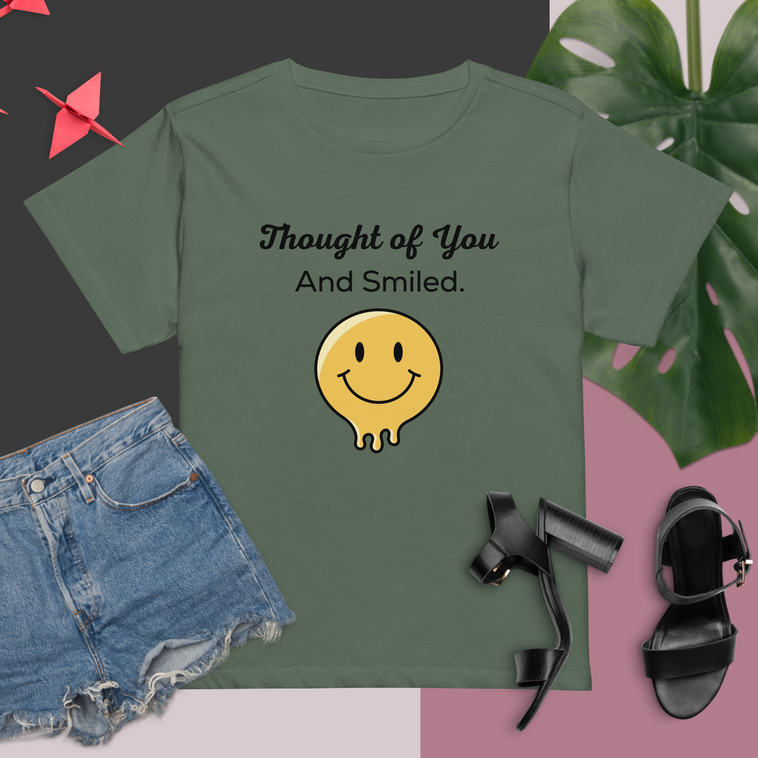 Green t-shirt with the text "Thought of You And Smiled." above a yellow, black-outlined, melting smiley face graphic | IslandWear Fashion 