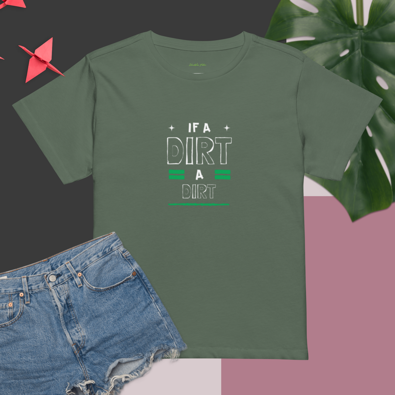 Pine color t-shirt featuring the graphic "If A Dirt, A Dirt" Jamaican slang in white and green text. Shirt is styled with denim shorts and a tropical leaf | IslandWear Fashion 